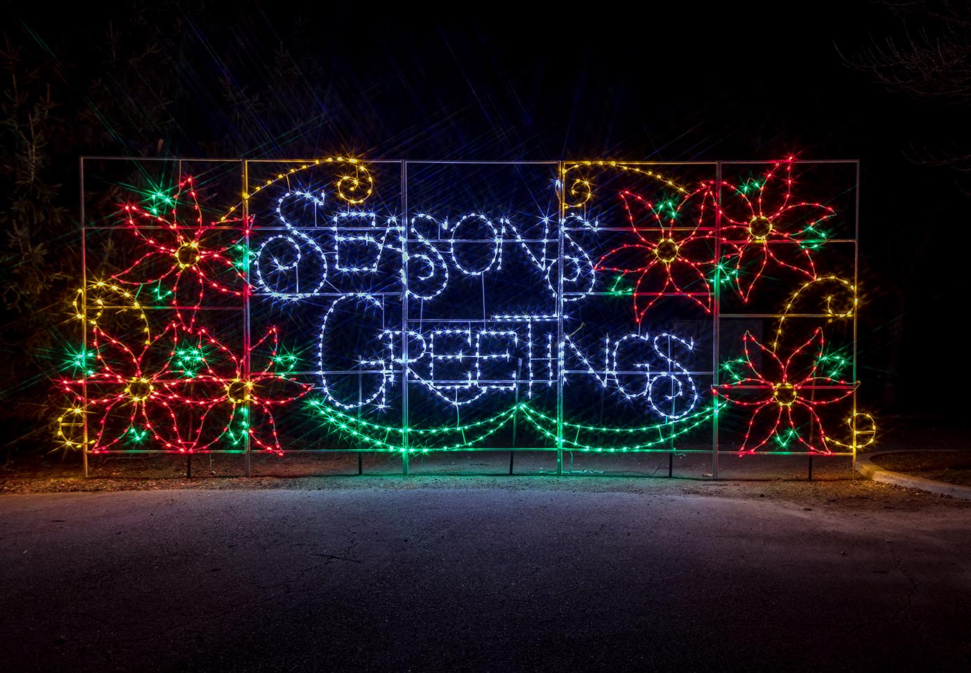 holiday lights spelling out "Seasons Greetings"