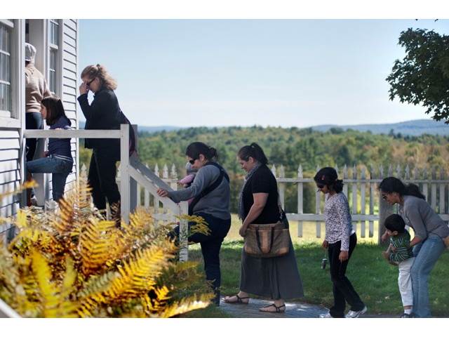A group of visitors enter the Historic Shaker Meeting House.