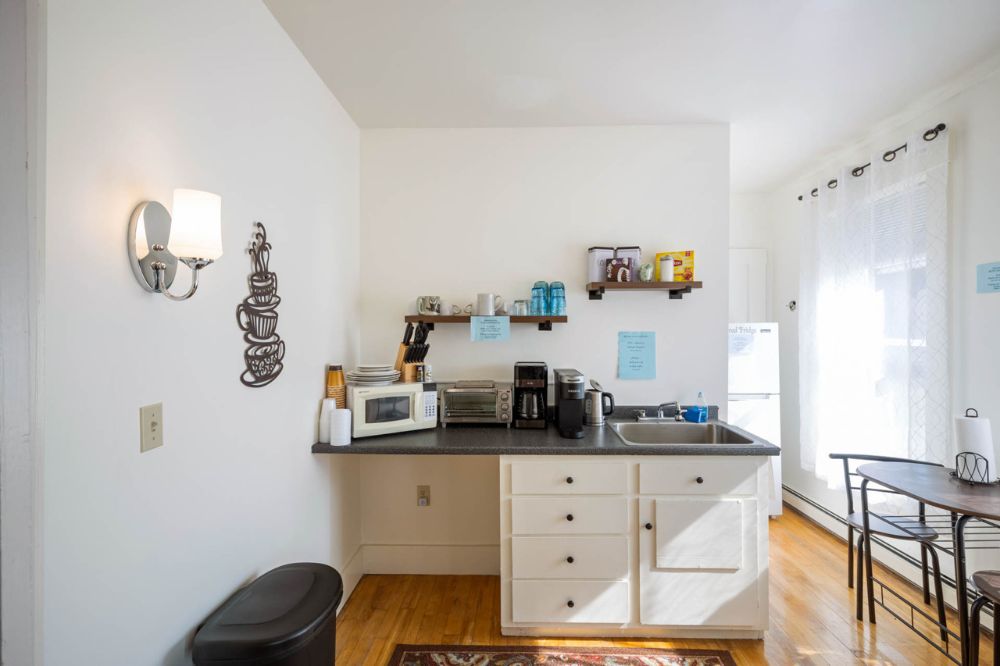 The Kitchenette, shared for all 7 rooms. All the conveniences... fridge, toaster oven, microwave, coffee maker, Keurig (bring your K-cups) & a Hot Pot 