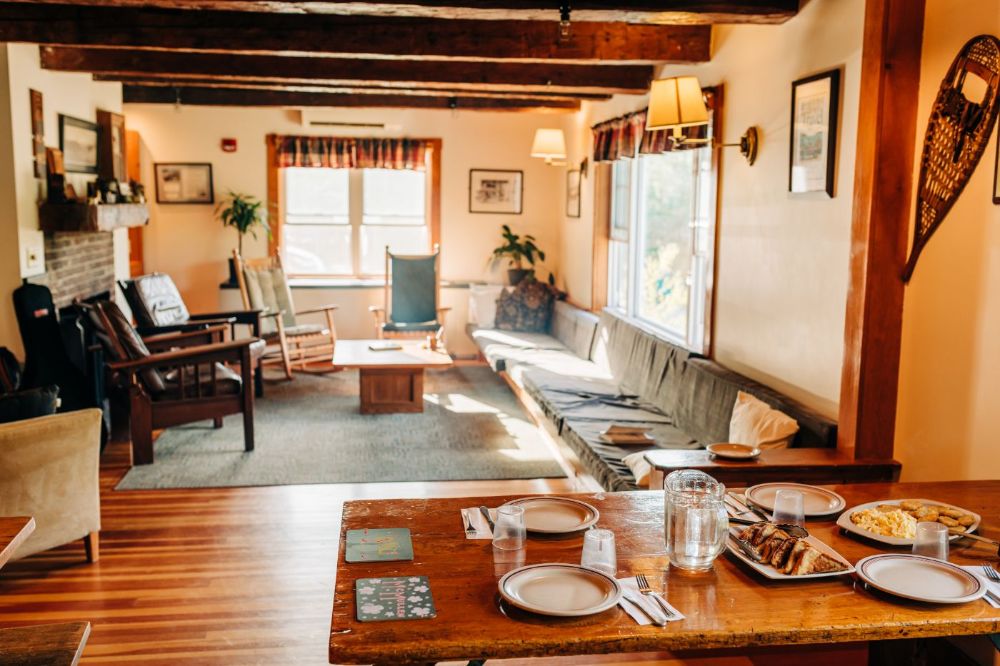If you prefer to be indoors, there is a large dining room with tables and a comfortable sitting room on the main floor, as well as a small library/game room downstairs. Photo by Corey David Photography 