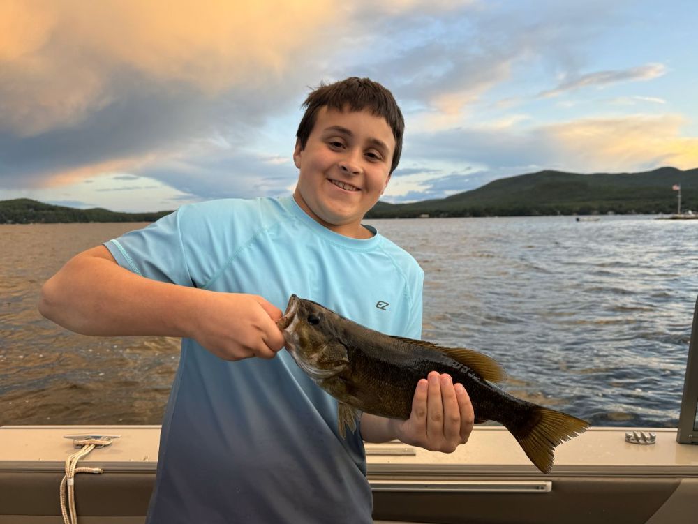 Nice chunky smallmouth caught under a colorful sky on Lake Winnipesaukee