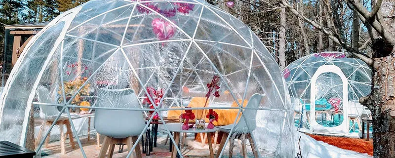 Warm transparrent domes set up on an outdoor patio for wine tasting in winter